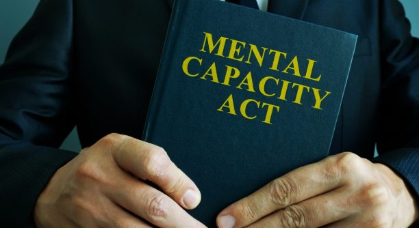 Man is holding mental capacity act.