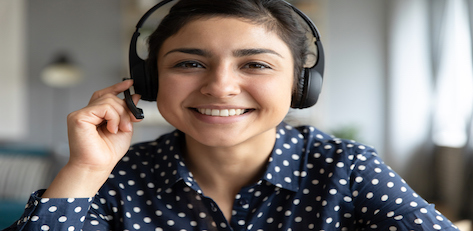 woman with headset wearing a spotted blouse