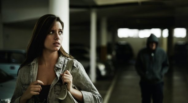 a girl being followed in an underground car park